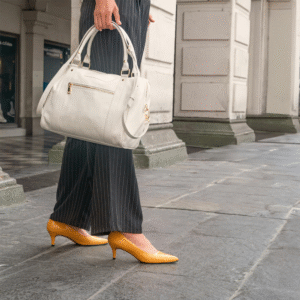 外反母趾悪化につながる細いつま先のパンプスで歩く写真